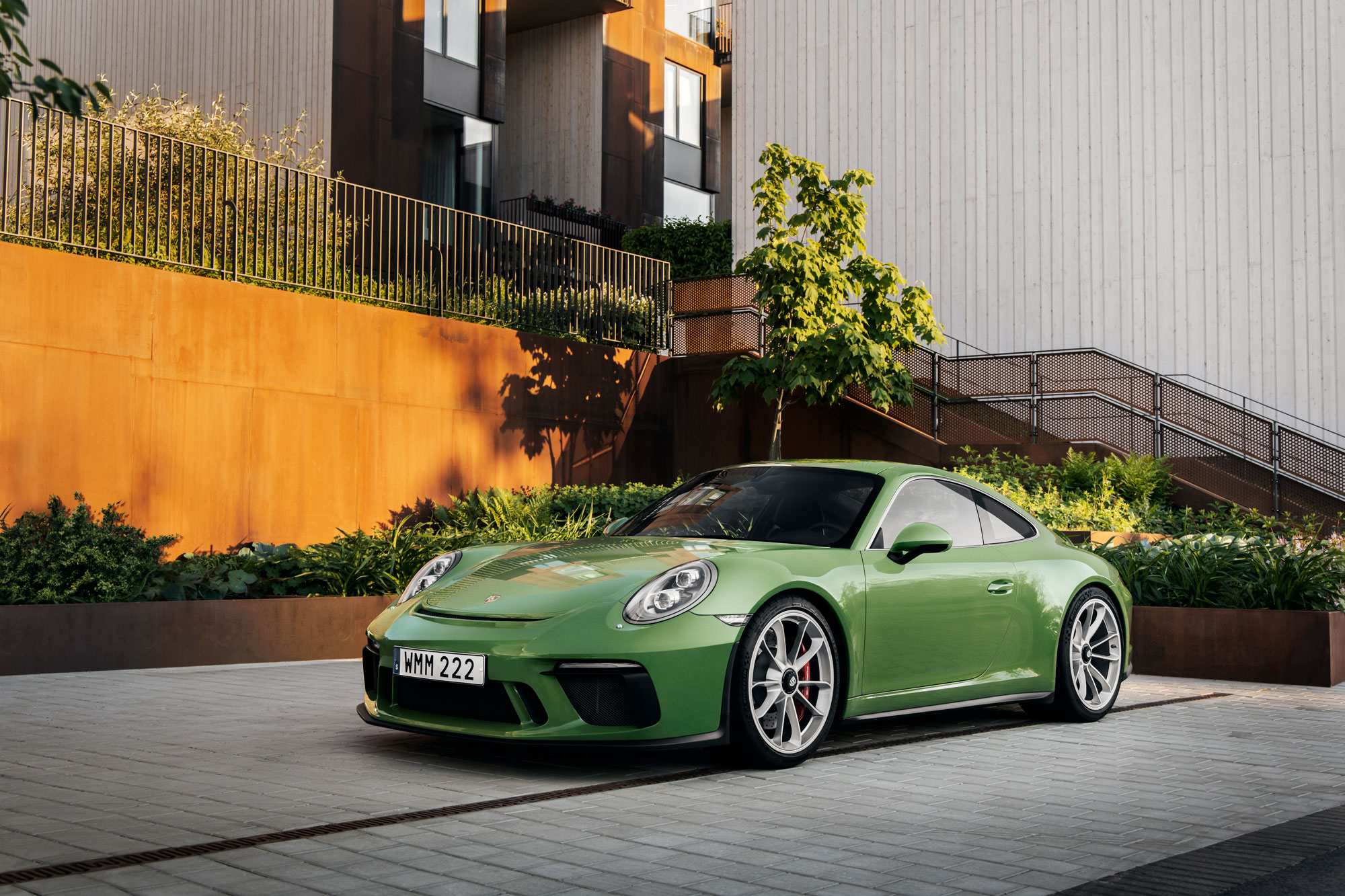 Porsche 911 parked in front of luxurious apartments